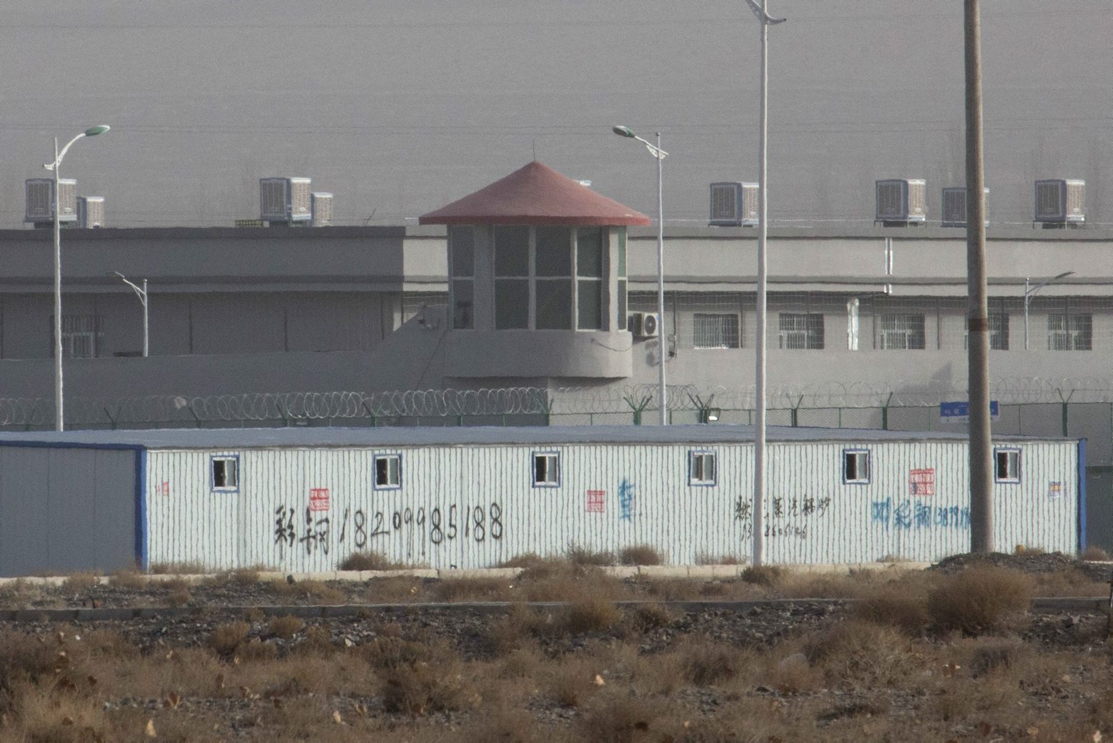 FILE.- In this Monday, Dec. 3, 2018, file photo, a guard tower and barbed wire fences are seen around a facility in the Kunshan Industrial Park in Artux in western China's Xinjiang region. This is one of a growing number of internment camps in the Xinjiang region, where by some estimates 1 million Muslims are detained, forced to give up their language and their religion and subject to political indoctrination. Highly confidential blueprint documents leaked to a consortium of news organizations lay out the Chinese government's deliberate strategy to lock up ethnic minorities to rewire their thoughts and even the language they speak.(AP Photo/File) The China Cables