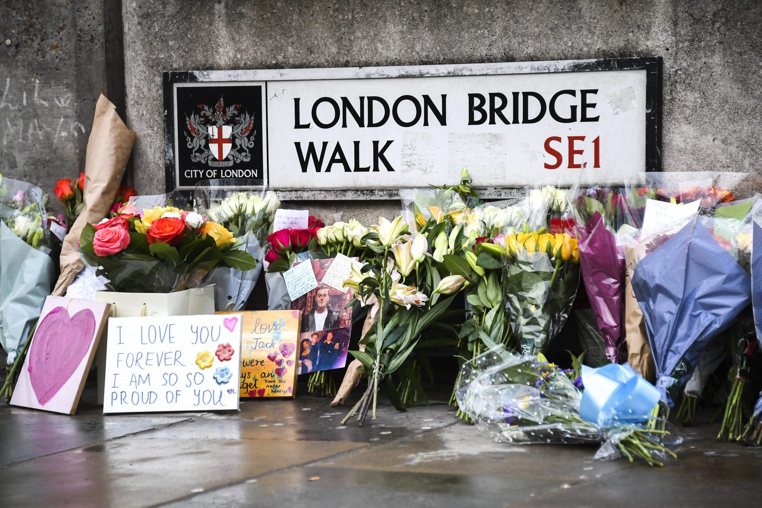 Flowers and a pictures are left in memory of Jack Merritt, the first person named as a victim of Friday's terror attack. A man wearing a fake suicide vest was subdued by bystanders as he went on a knife rampage killing two people and wounding others before being shot dead by police on Friday. (AP Photo/Alberto Pezzali) Britain London Attack