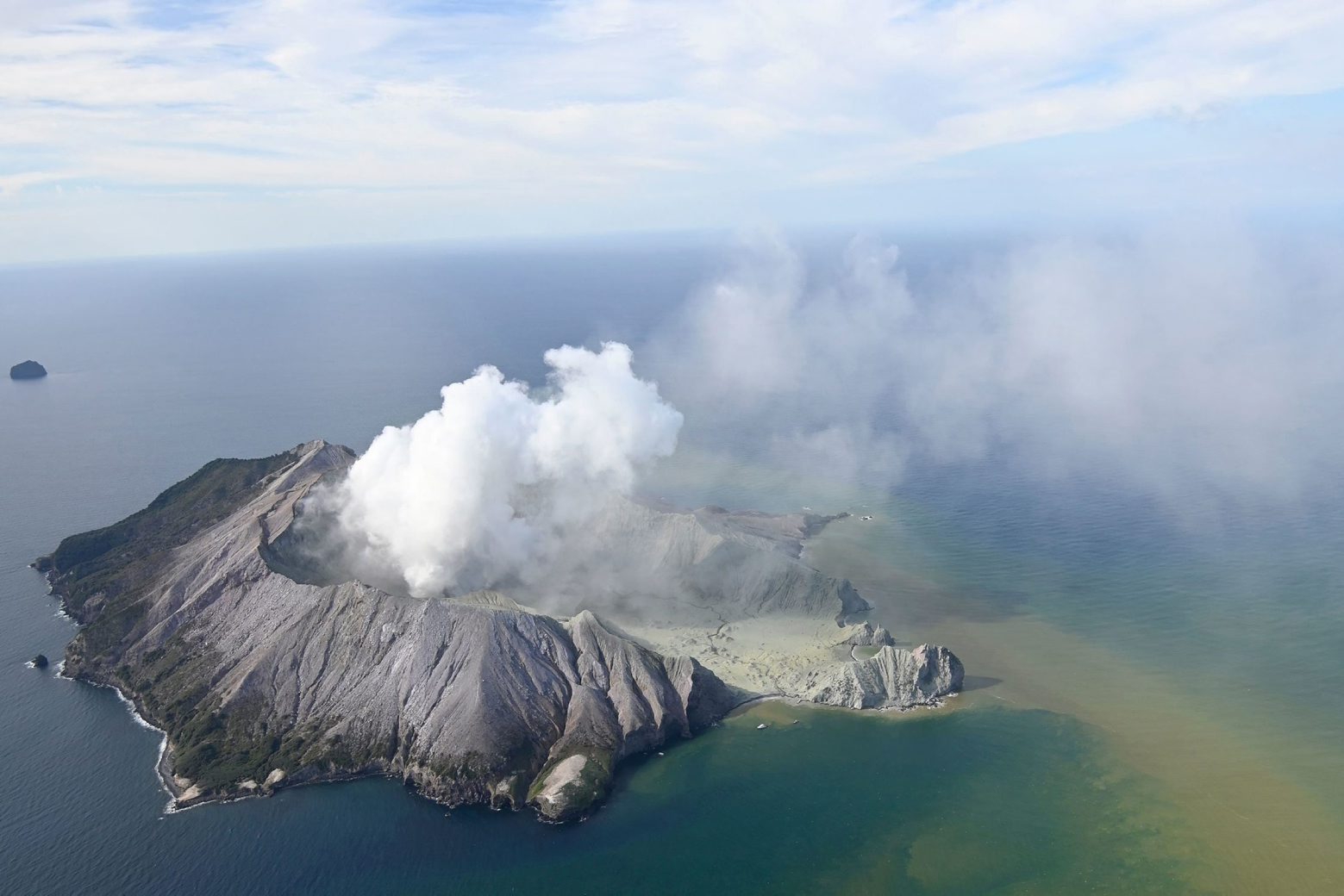 This aerial photo shows White Island after its volcanic eruption in New Zealand Monday, Dec. 9, 2019. The volcano on a small New Zealand island frequented by tourists erupted Monday, and a number of people were missing and injured after the blast. (George Novak/New Zealand Herald via AP) New Zealand Volcano Erupts