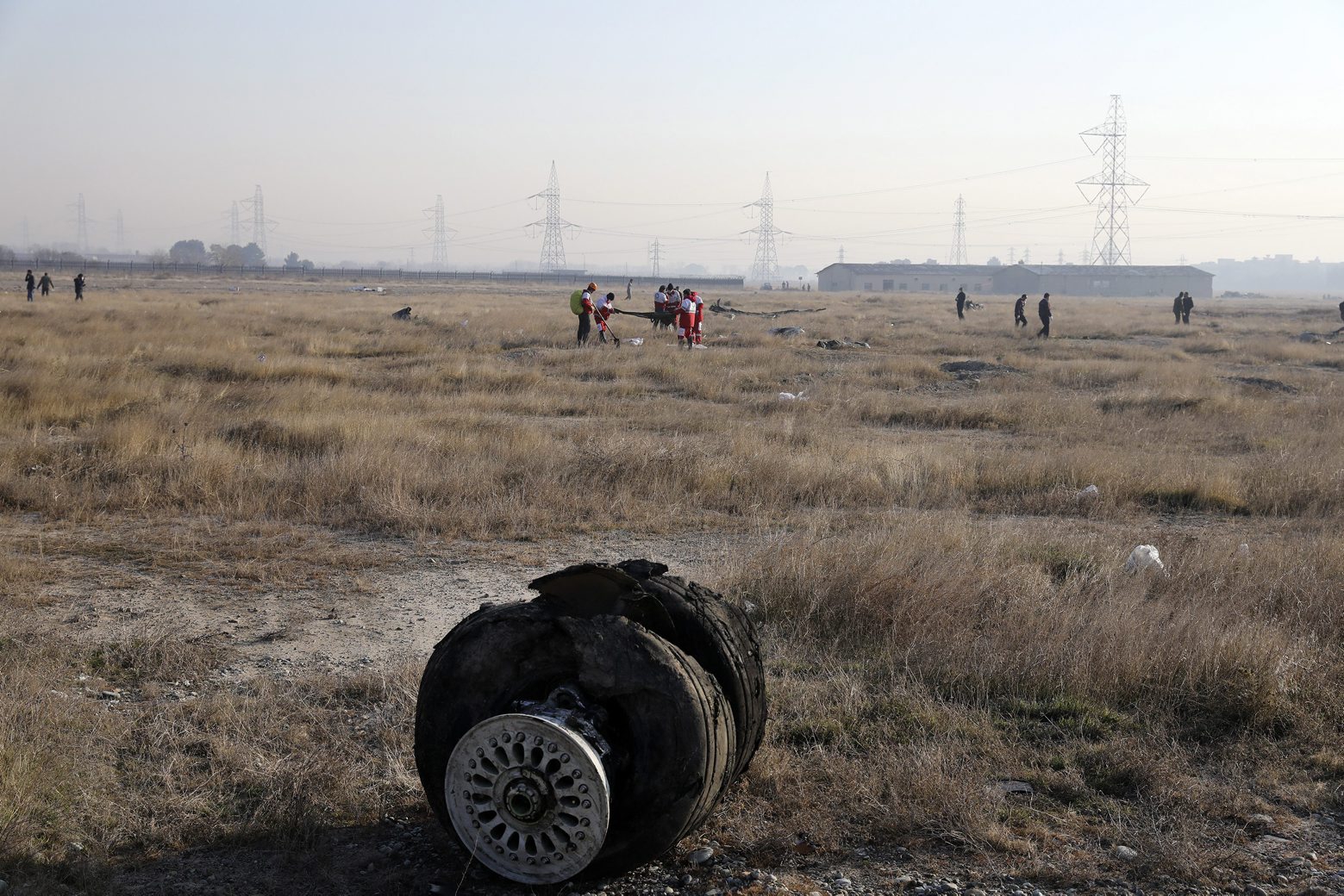 Debris is seen from an Ukrainian plane which crashed as rescue workers search the scene in Shahedshahr, southwest of the capital Tehran, Iran, Wednesday, Jan. 8, 2020. A Ukrainian airplane carrying 176 people crashed on Wednesday shortly after takeoff from Tehran's main airport, killing all onboard. (AP Photo/Ebrahim Noroozi) Iran Plane Crash