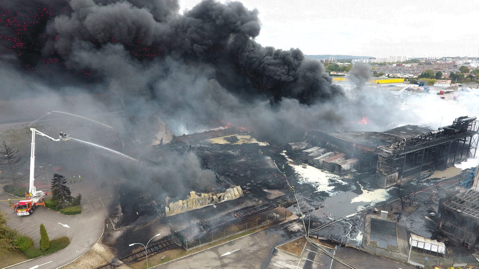 epa07888290 A handout photo taken with a drone and made available by the Departmental Fire and Rescue Service (Service Departemental d'Incendie et de Secours, SDIS) of the Seine-Maritime, France on 02 October 2019 shows firefighters trying to extinguish a large fire that broke out during the night at the Lubrizol factory in the northern port city of Rouen, France, 26 September 2019. Locals asked for more information from French authorities on the impact of this huge blaze amid fears for health and the environment.  EPA/SDIS 76 HANDOUT  HANDOUT EDITORIAL USE ONLY/NO SALES FRANCE LUBRIZOL FIRE