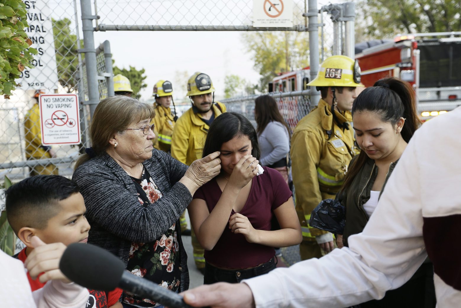 Student Marianna Torres, 11, center, cries as she evacuates Park Avenue Elementary School after jet fuel fell on the school in Cudahy, Calif., Tuesday, Jan. 14, 2020. Jet fuel dumped by an aircraft returning to Los Angeles International Airport fell onto the school playground where children were playing Tuesday, fire officials said. The Los Angeles County Fire Department said firefighters assessed over a dozen children and several adults who complained of minor injuries and none needed to be taken to a hospital. (AP Photo/Damian Dovarganes)
Teresa Santoya,Marianna Torres,Pamela Amador Aircraft Fuel Dump