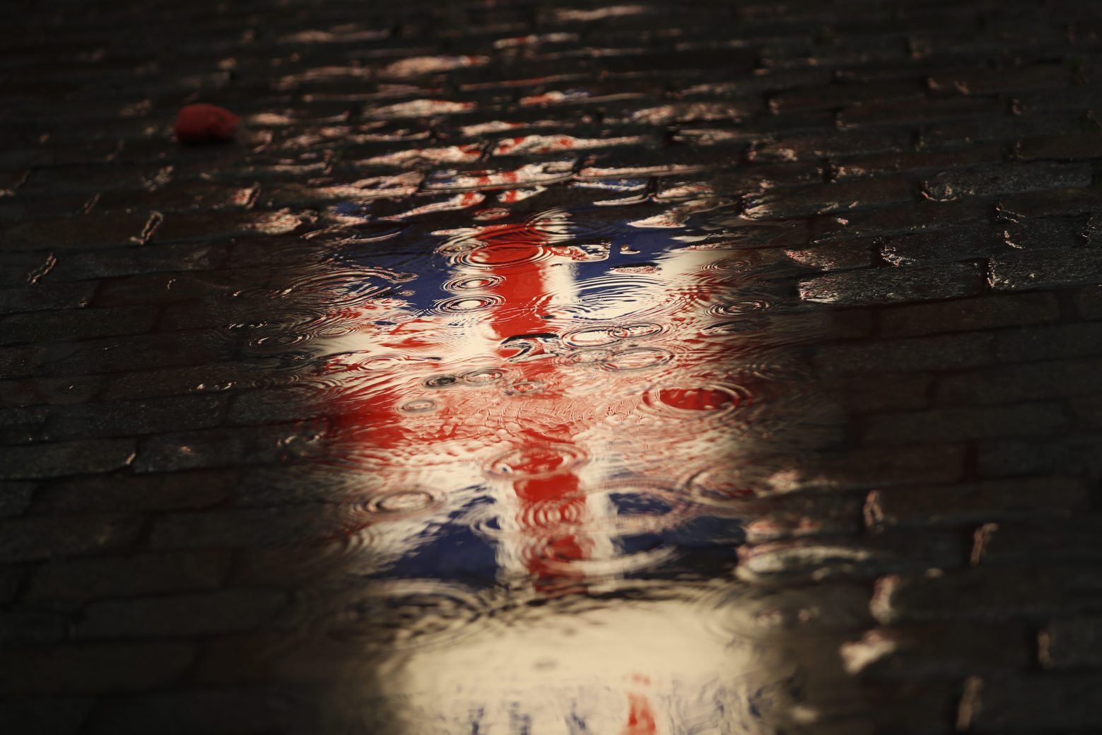 The Union flag is reflected in a puddle during an event called "Brussels calling" to celebrate the friendship between Belgium and Britain at the Grand Place in Brussels, Thursday, Jan. 30, 2020. The European Union grudgingly let go of the United Kingdom with a final vote Wednesday at the EU's parliament that ended the Brexit divorce battle and set the scene for tough trade negotiations in the year ahead. (AP Photo/Francisco Seco) Belgium Britain Brexit