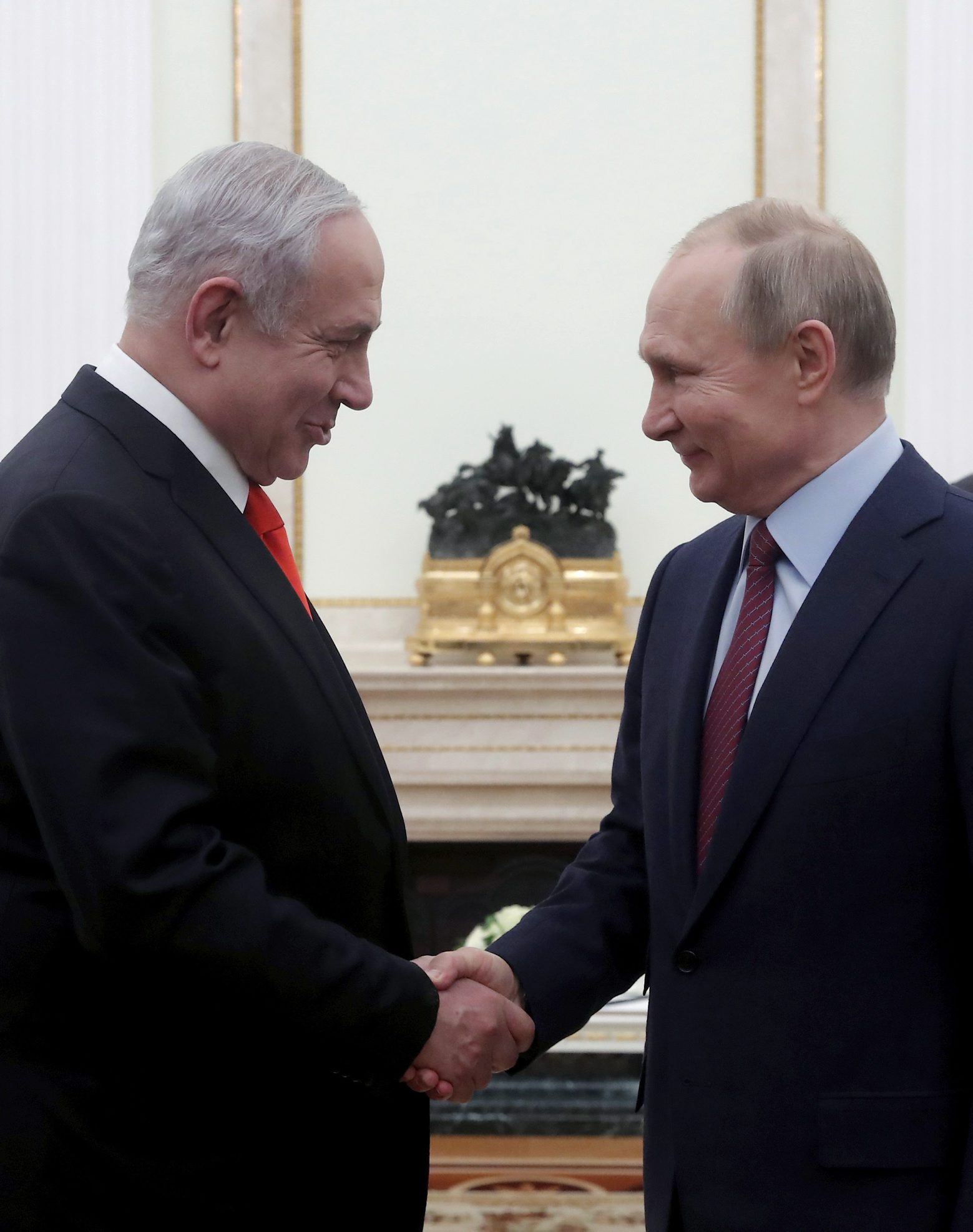Russian President Vladimir Putin, right, shakes hands with Israeli Prime Minister Benjamin Netanyahu during their meeting in the Kremlin in Moscow, Russia, Thursday, Jan. 30, 2020. Netanyahu visited Moscow to discuss the U.S. Mideast peace plan with Putin and take an Israeli woman who had been jailed in Russia back home. (Maxim Shemetov/Pool Photo via AP) Russia Israel