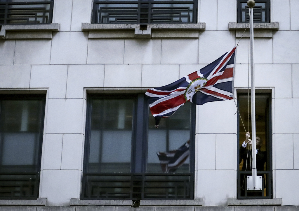 A member of protocol hoists the Union flag after removing the EU flag from the UK Permanent Representation to the EU in Brussels, Friday, Jan. 31, 2020. As the United Kingdom prepared to bring to an end its 47-year EU membership, the bloc's top officials on Friday pledged to continue playing a prominent role despite the loss of a powerful affiliate. (Olivier Hoslet, Pool Photo via AP)