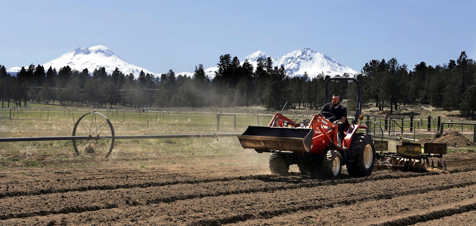 FILE - In this April 23, 2018, file photo, Trevor Eubanks, plant manager for Big Top Farms, readies a field for another hemp crop near Sisters, Ore. Draft rules released by the U.S. Department of Agriculture for a new and booming agricultural hemp industry have alarmed farmers, processors and retailers across the country, who say the provisions will be crippling if they are not significantly overhauled before they become final. (AP Photo/Don Ryan, File)
Trevor Eubanks Hemp Regulations-Worried Growers