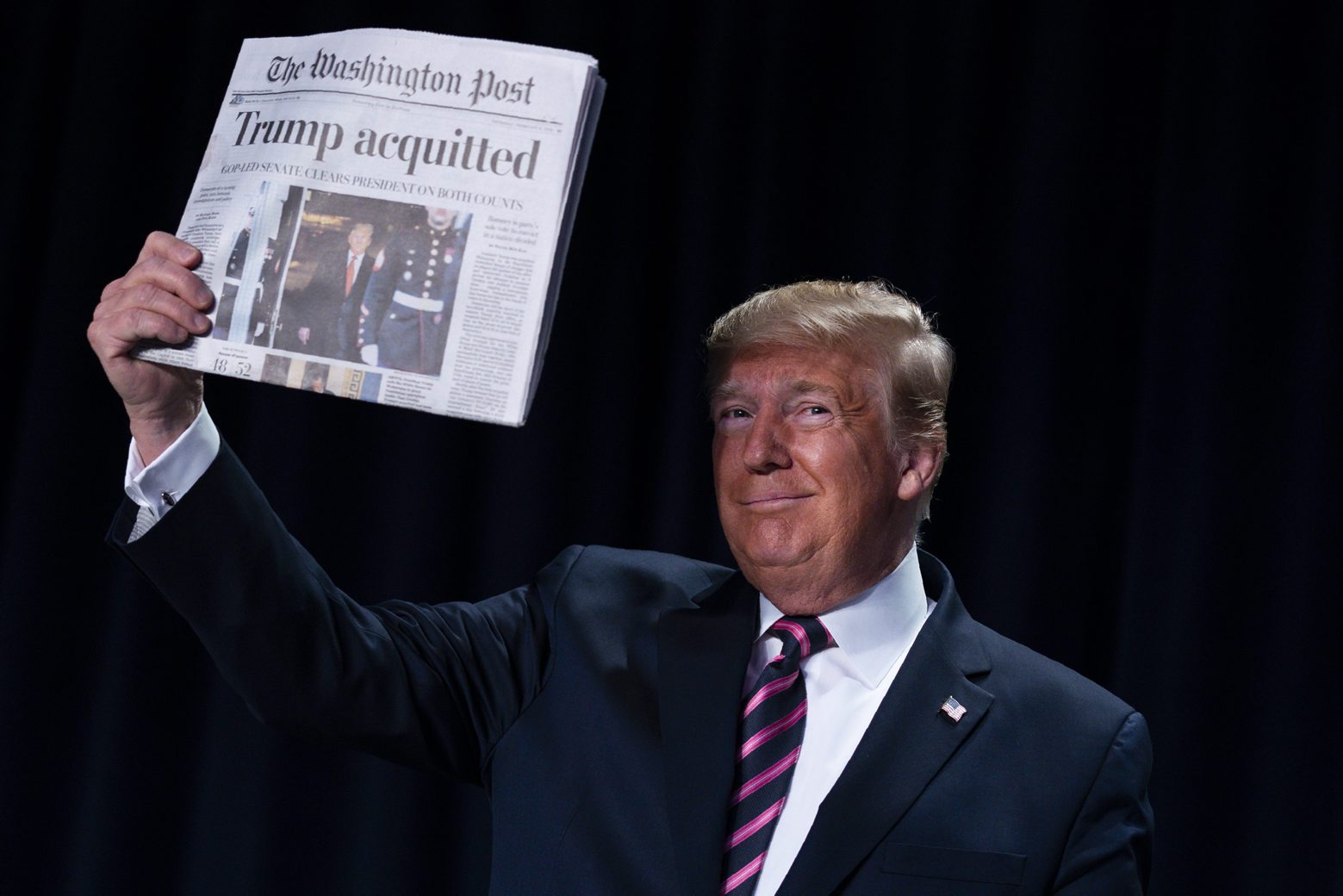 President Donald Trump holds up a newspaper during the 68th annual National Prayer Breakfast, at the Washington Hilton, Thursday, Feb. 6, 2020, in Washington. (AP Photo/ Evan Vucci)
Donald Trump Trump