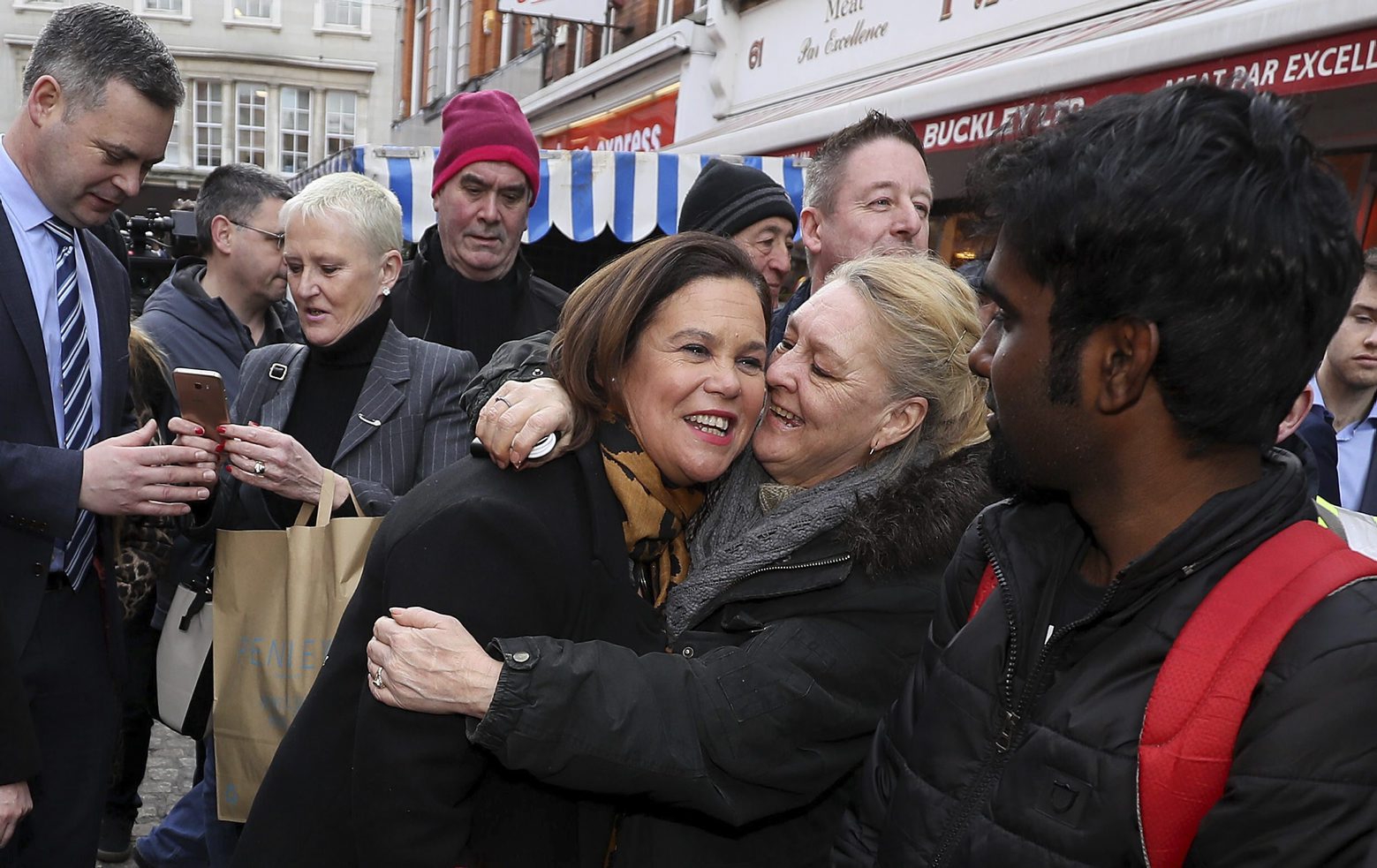 Sinn Fein leader Mary Lou McDonald, center, is greeted by well wishers during a walkabout in central Dublin during a walkabout in central Dublin, whilst on the General Election campaign trail on Thursday, Feb. 6, 2020. Ireland goes to the polls for a general election on Feb. 8. (Brian Lawless/PA via AP) Ireland Elections