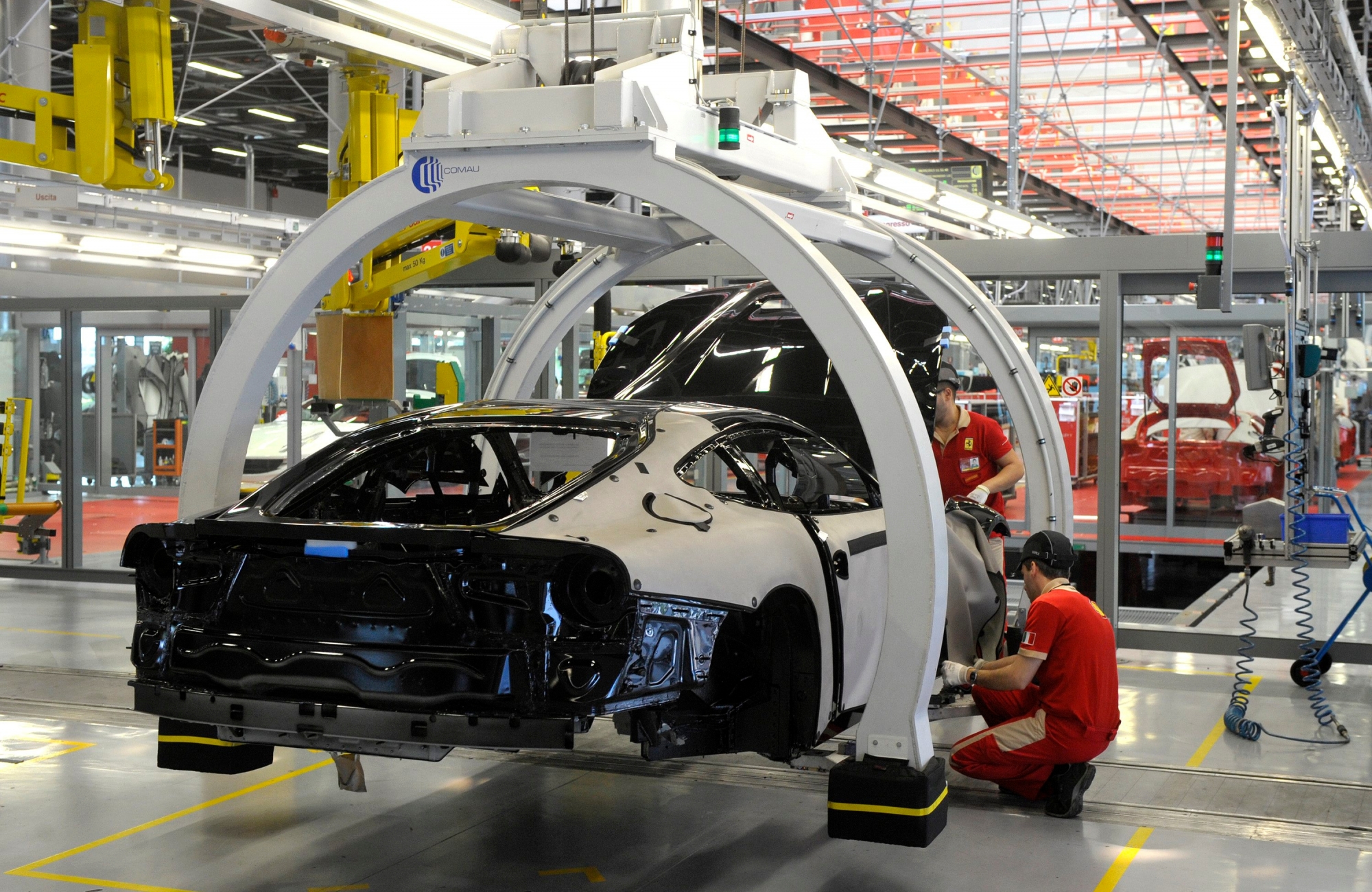 A technician works at the Ferrari department factory in Maranello, Italy, Wednesday, May 8, 2013. Ferrari will limit sales of its high-performance street cars this year to protect the brand's aura of exclusivity, Chairman Luca Montezemolo said Wednesday. Wealthy people around the world are snapping up Ferrari's and the company is worried the brand might lose its appeal as a symbol of rarefied luxury. As a result, it will scale back production to below 7,000 units this year, compared with 7,318 last year. "The exclusivity of Ferrari is fundamental for the value of our products," Montezemolo told journalists at the company headquarters near Modena, in northern Italy. "We don't sell a normal product. We sell a dream." (AP Photo/Marco Vasini).. ITALIEN AUTO FERRARI