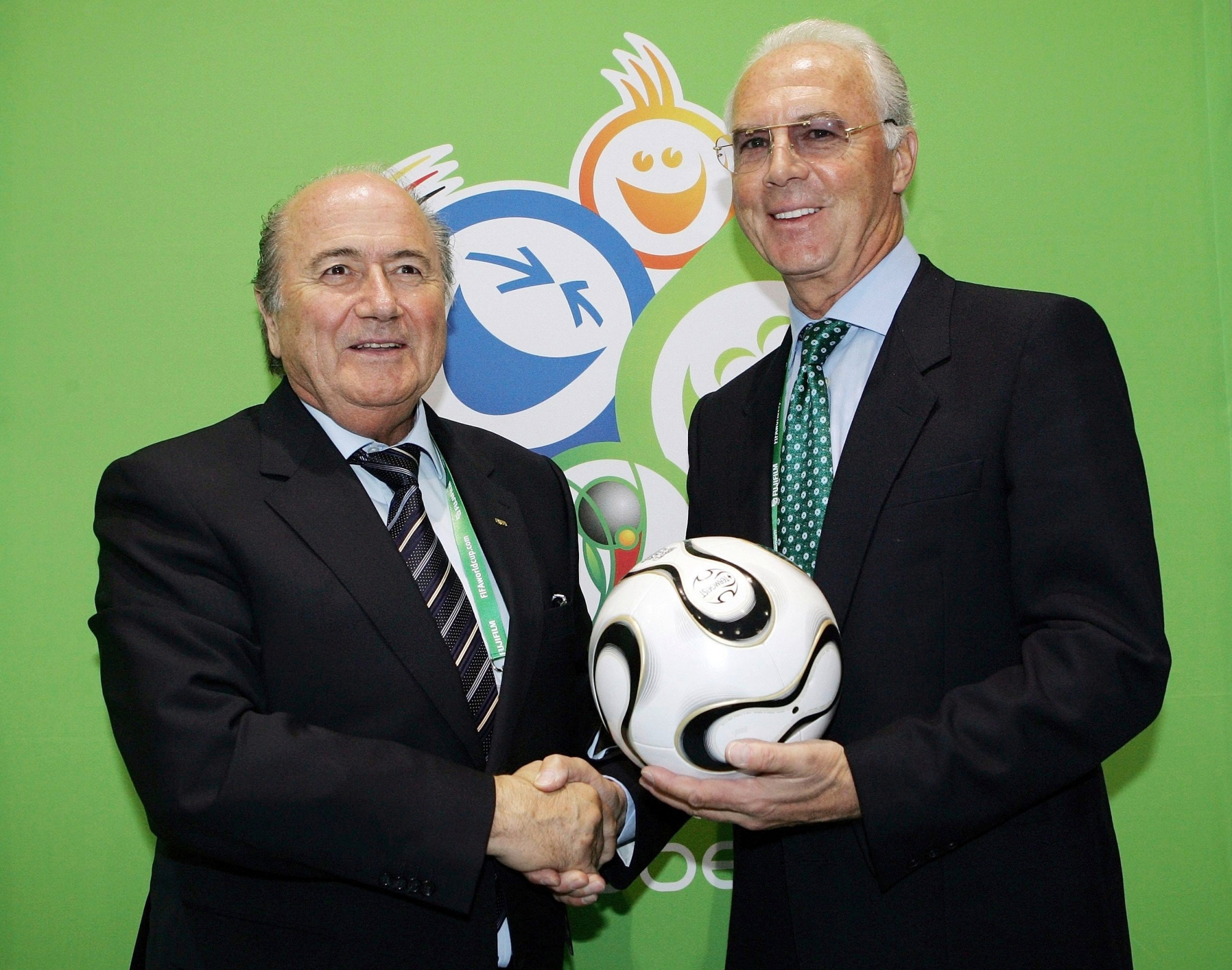 FIFA President Joseph Blatter, left, and Franz Beckenbauer, World Cup organizing commitee head, right, poses for photographers during a FIFA news conference in the international broadcast center in Munich, southern Germany, on Tuesday, June 6, 2006. The opening match of the Soccer World Cup 2006 will be in the stadium in Munich on Friday, June 9, 2006. (AP Photo/Christof Stache) WCUPWORLDCUPSOCCERGERMANY