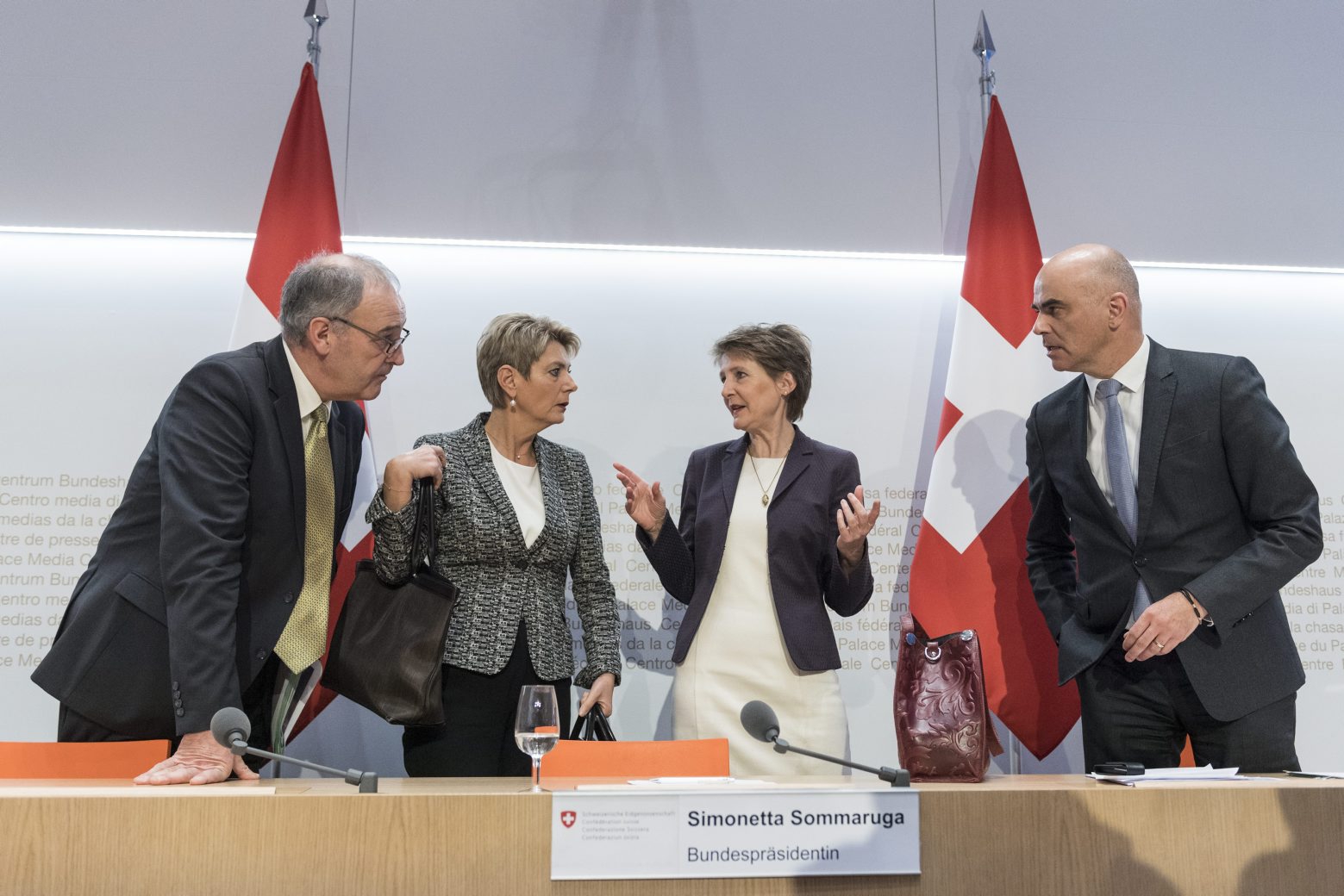 Swiss Federal president Simonetta Sommaruga, second right, and from left, Federal councillors Guy Parmelin, Karin Keller-Sutter and Alain Berset talk after the media briefing about the latest measures to fight the Covid-19 Coronavirus pandemic, on Friday, March 13, 2020 in Bern, Switzerland. (KEYSTONE/Alessandro della Valle) SWITZERLAND GOVERNMENT CORONAVIRUS