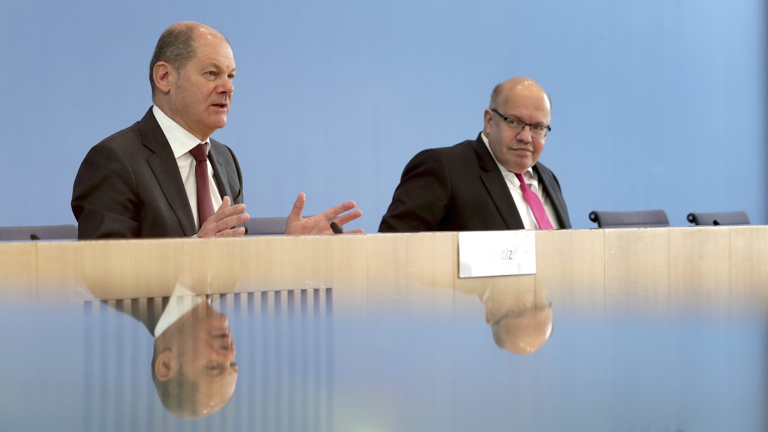 German Finance Minister Olaf Scholz, left, and German Economy Minister, Peter Altmaier, right, address the media in Berlin, Germany, Monday, March 23, 2020 during a press conference on the supplemental budget 2020 and how the ministries will react against the new coronavirus. For most people, the new coronavirus causes only mild or moderate symptoms. For some it can cause more severe illness (AP Photo/Michael Sohn, pool) Virus Outbreak Germany Economy