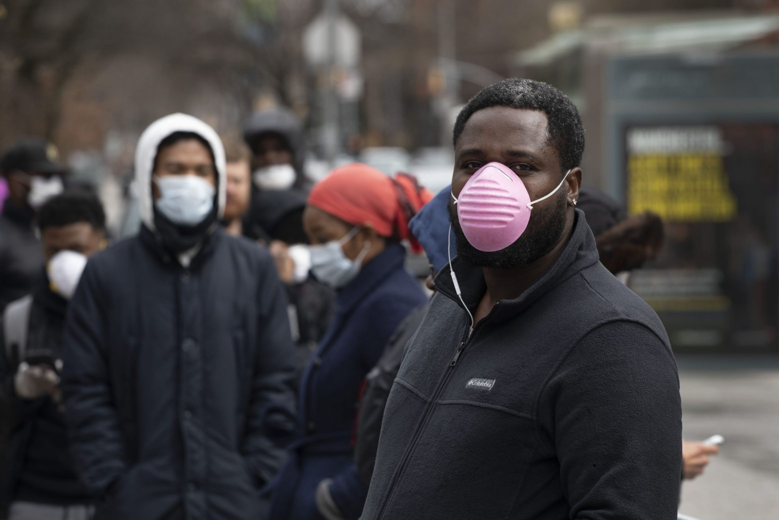 David Cadet, right, waits in line outside a coronavirus screening tent at the Brooklyn Hospital Center, Thursday, March 19, 2020 in New York. Cadet does not think he has the virus but is having a screening just in case. "You have to protect them," he says of his wife and child. (AP Photo/Mark Lennihan) Virus Outbreak New York