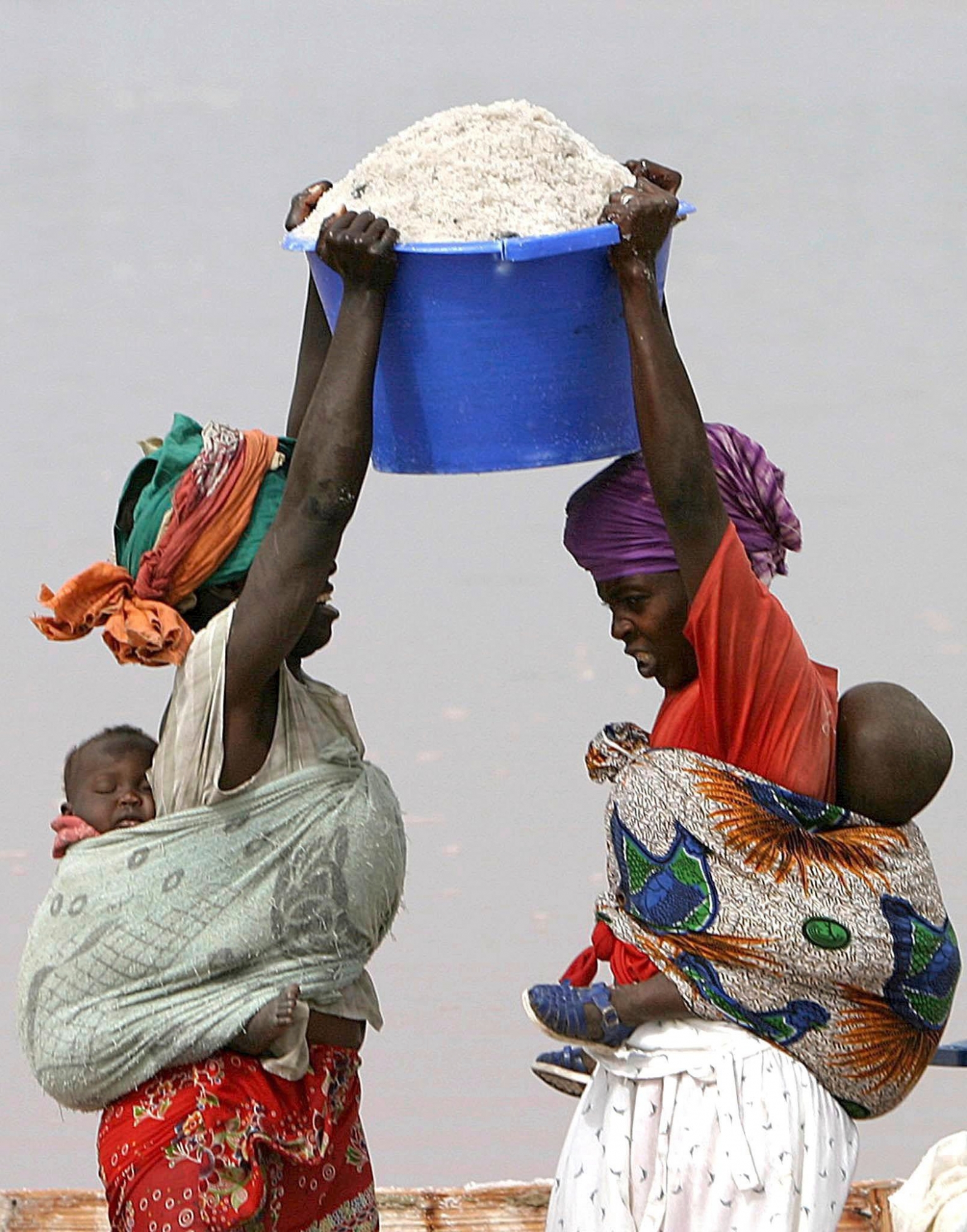 epa000455118 DEBT RELIEF SENEGAL

(FILES) Senegalese woman carrying children on their backs lift a bucket of salt from a boat to carry it ashore at Lac Rose (Pink Lake) in Senegal, Thursday 24 February 2005. Senegal is one of the 18 nations that will with immediate effect benefit from the total debt relief that was decided Saturday 11 June 2005 at the finance ministers meeting of the seven leading industrial nations and Russia in London. Under the plan, 14 of the poorest nations in Africa--Benin, Burkina Faso, Ethiopia, Ghana, Madagascar, Mali, Mauritania, Mozambique, Niger, Rwanda, Senegal, Tanzania, Uganda and Zambia--and four in Latin America--Bolivia, Guyana, Honduras and Nicaragua--would be allowed to cancel out their debts.  EPA/NIC BOTHMA SENEGAL DEBT RELIEF