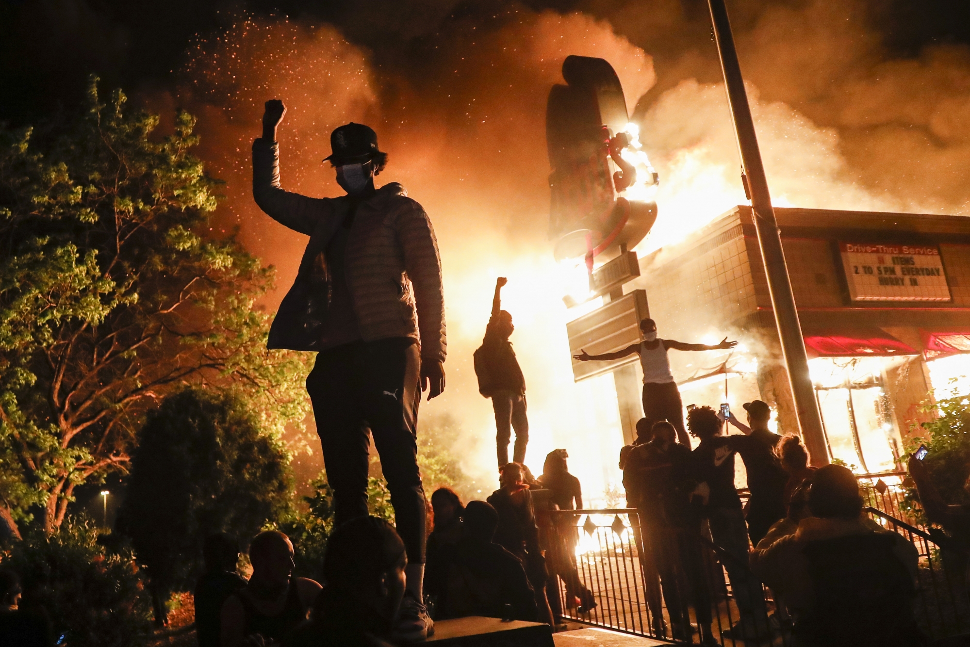 Protestors demonstrate outside of a burning fast food restaurant, Friday, May 29, 2020, in Minneapolis. Protests over the death of George Floyd, a black man who died in police custody Monday, broke out in Minneapolis for a third straight night. (AP Photo/John Minchillo)
ArcInfo APTOPIX Minneapolis Police Death