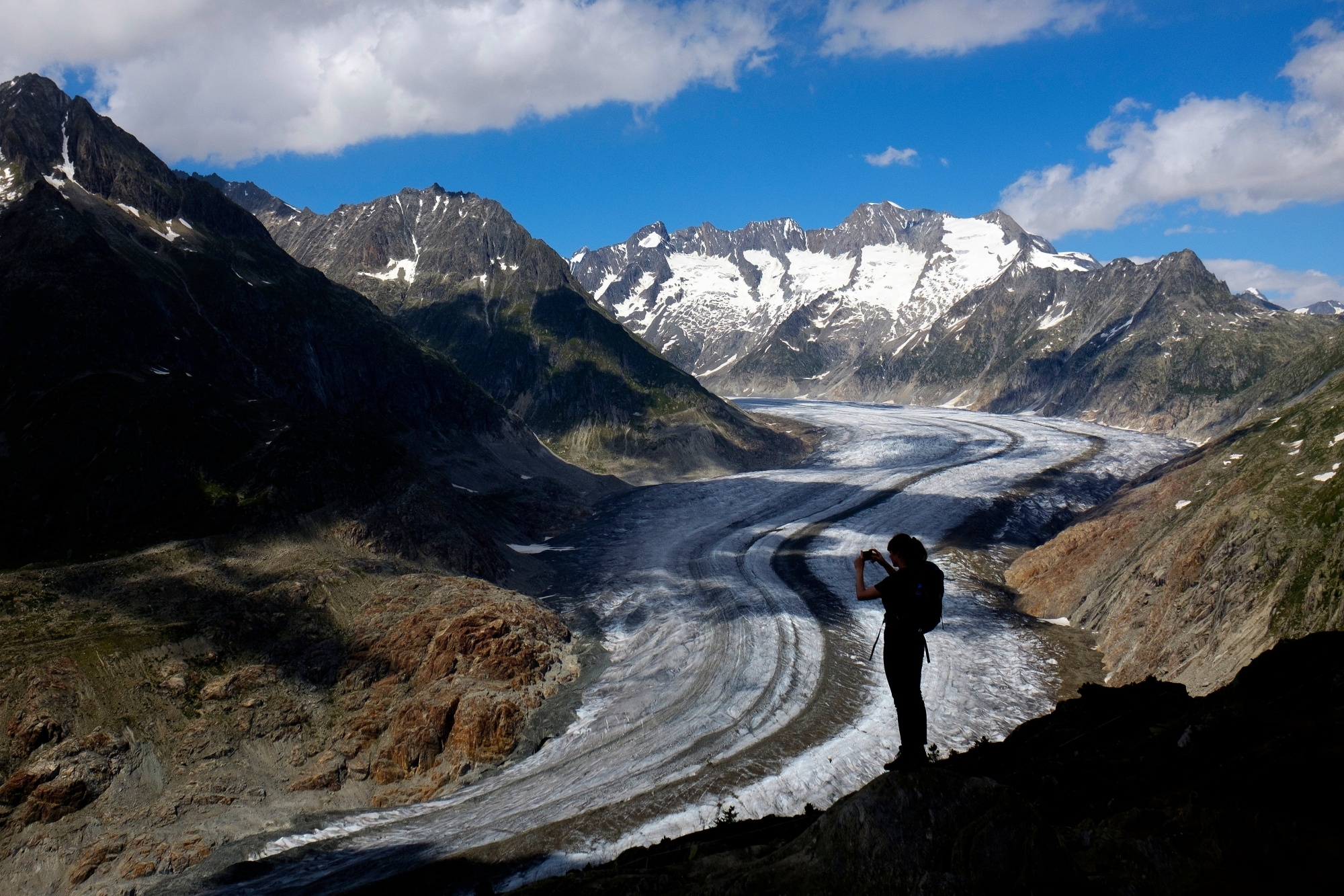 A woman takes a picture with her smartphone of the Swiss Aletsch Glacier during a beautiful summer day above Bettmeralp in Wallis, Switzerland, this Saturday, July 7, 2018. The Swiss Aletsch glacier, one of the largest ice streams in Europe, is the first Unesco World Heritage Site of the Alps. This huge river of ice that stretches over 23 km from its formation in the Jungfrau region (at 4000 m) down to the Massa Gorge in Wallis, around 2500 m below, fascinates and inspires every visitor. (KEYSTONE/Anthony Anex)
ArcInfo