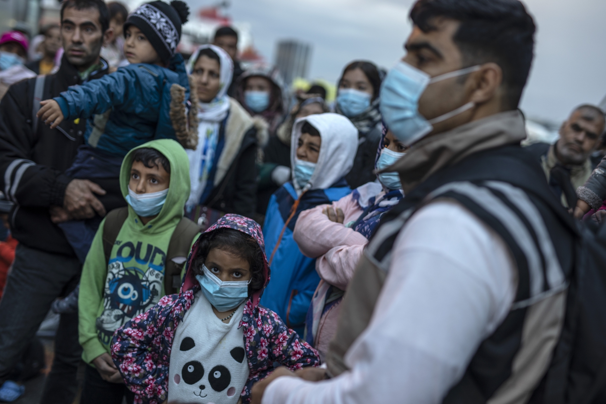 Refugees and migrants wearing masks to prevent the spread off the coronavirus, wait to get on a bus after their arrival at the port of Piraeus , near Athens, on Monday, May 4, 2020. Greek authorities are moving 400 migrants, mostly families, to the mainland to help ease overcrowded conditions at the camp Moria in Lesbos island. (AP Photo/Petros Giannakouris)
ArcInfo