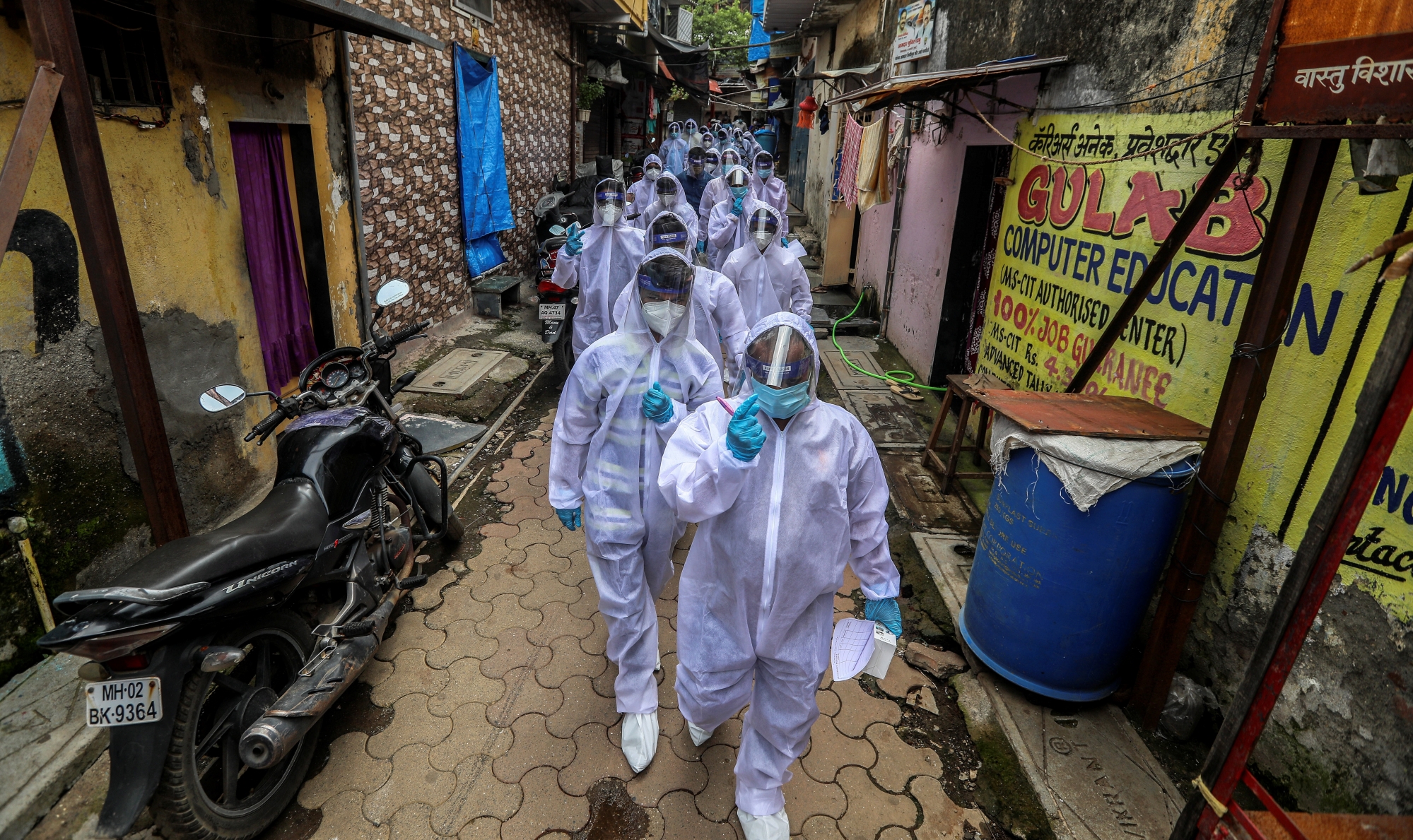 epa08514157 Indian health workers wearing personal protective equipment (PPE) arrive to carry medical checkup of the residents of a 'containment zones' in Appa Pada area, a COVID-19 hotspot, in Mumbai, India, 28 June 2020. The Indian government has eased some coronavirus related restrictions but has said the lockdown will continue until 30 June, in 'containment zones'. According to the latest reports, India has surpassed 500,000 confirmed coronavirus cases.  EPA/DIVYAKANT SOLANKI
ArcInfo