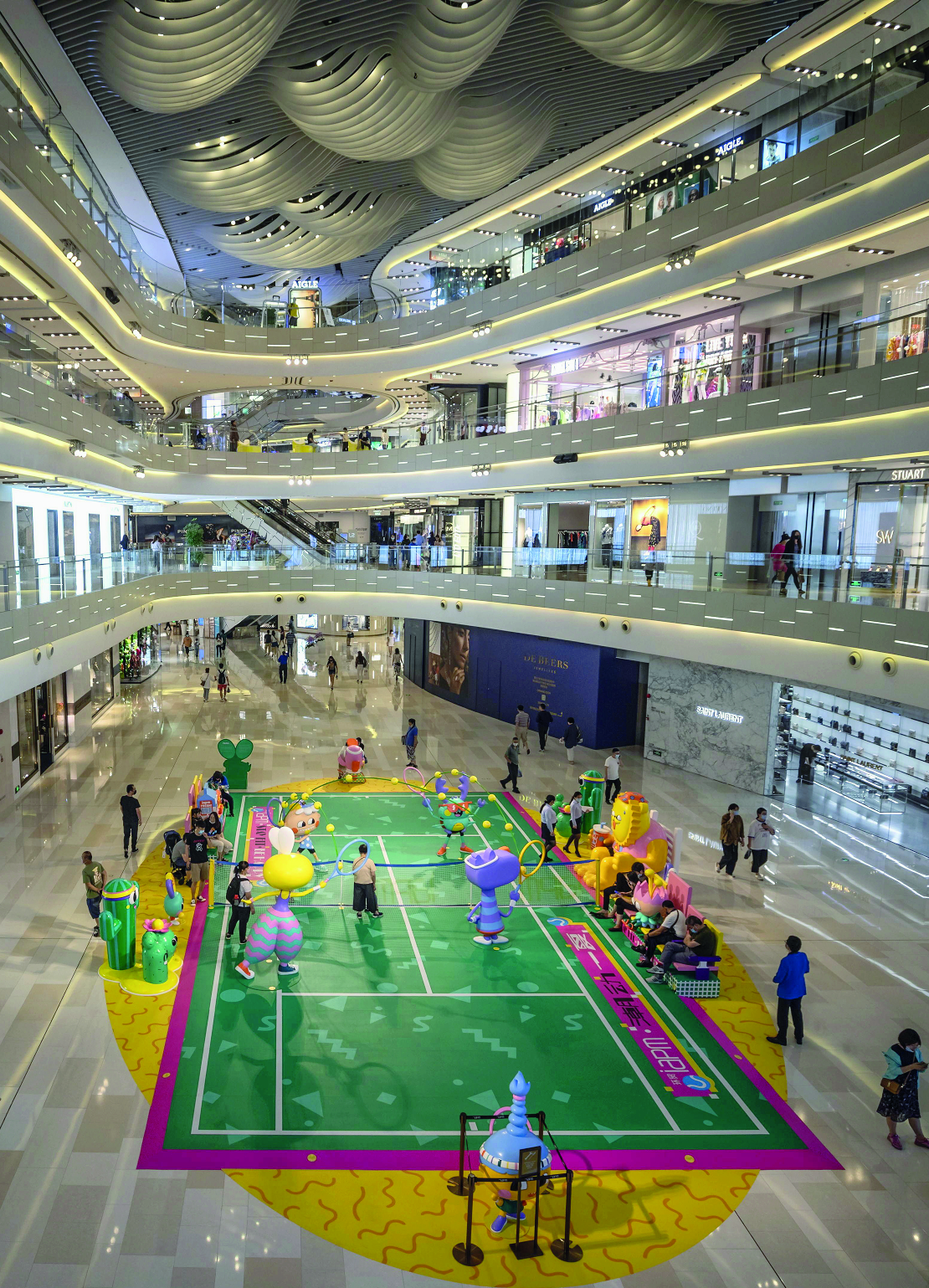 epa08548798 Visitors walk through a shopping mall with a badminton court in Shanghai, China, 15 July 2020 (issued 16 July 2020). China's gross domestic product (GDP) grew 3.2 percent in the second quarter of 2020, according to a report of the National Bureau of Statistics issued on 16 July 2020.  EPA/ALEX PLAVEVSKI ArcInfo