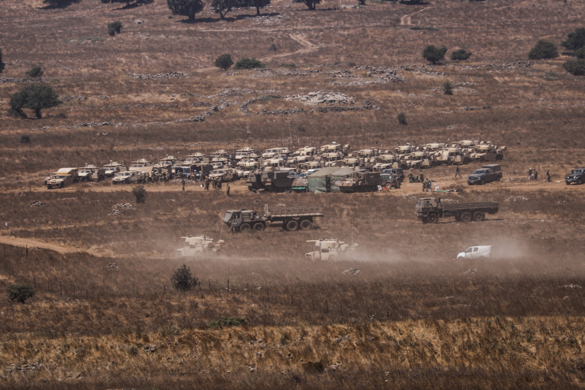 epaselect epa08581648 Israeli troops at a gathering site next to the Israeli-Syrian border, in the Golan Heights 03 August 2020. According to an Israeli military spokesperson, four Syrian militants had been reportedly killed in the early morning by Israeli soldiers who thwarted an attempt to place improvised explosive devices (IEDs) near the Alpha Line between Syria and Israel, on the southern Golan Heights, adjacent to an army post.  EPA/ATEF SAFADI ArcInfo
