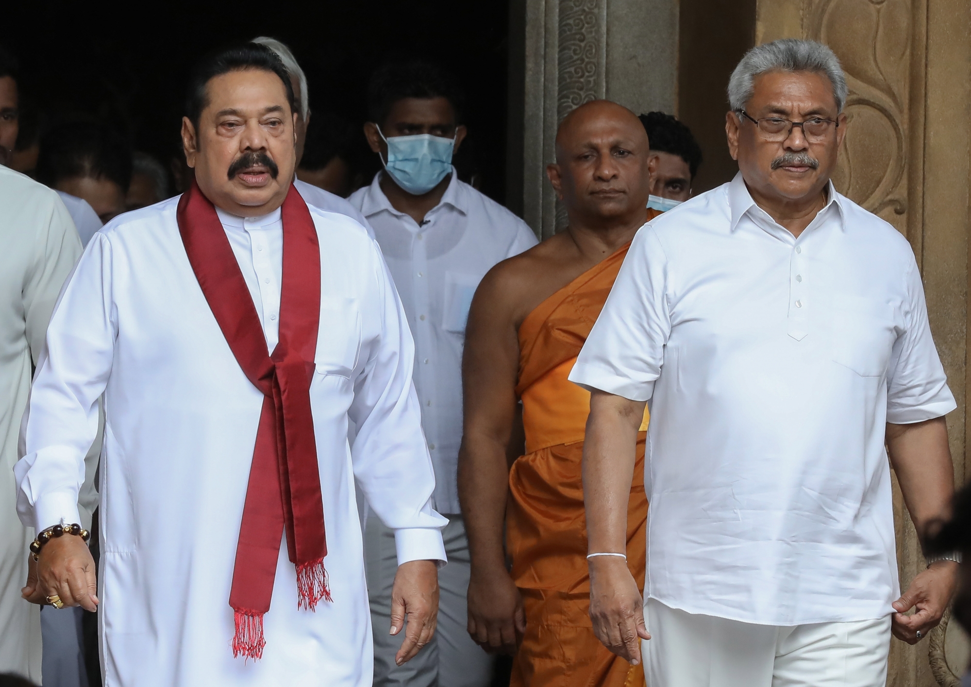 epa08592836 Sri Lanka's newly elected Prime Minister Mahinda Rajapaksa (L), his younger brother Sri Lankan President Gotabaya Rajapaksa (R) leave after the swearing-in ceremony at sacred Kelaniya Buddhist Temple in Colombo, Sri Lanka, 09 August 2020. Mahinda Rajapaksa, the two times executive President of Sri Lanka and three times Prime Minister, was sworn in as the Prime Minister of Sri Lanka for the fourth time. He was elected with a recorded number of preferential votes over 500,000 from Kurunegla district on 05 August parliamentary elections.  EPA/CHAMILA KARUNARATHNE ArcInfo